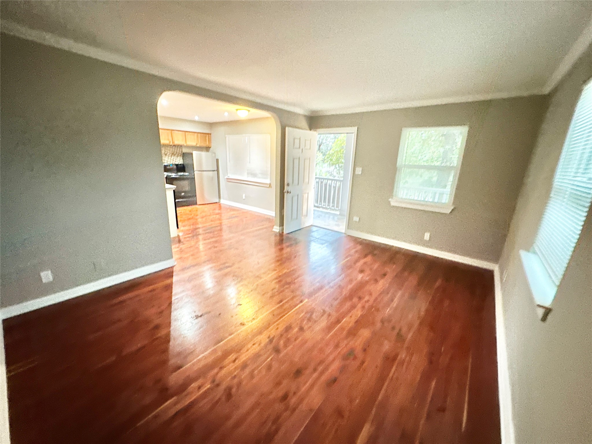 1302 South Quinlan Park Road Austin, TX 78732 - Photo 23 of 40 an empty room with wooden floor and windows