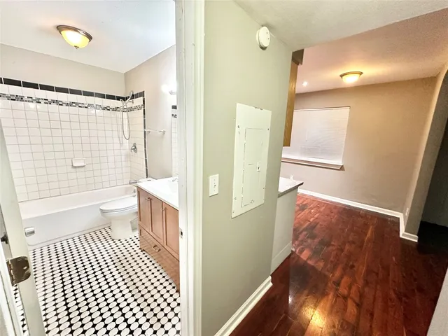 a bathroom with a sink a toilet a shower a vanity and a mirror