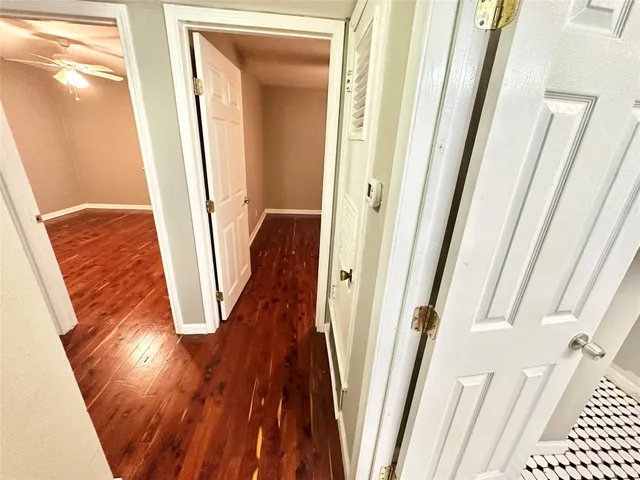 a view of a room with wooden floor