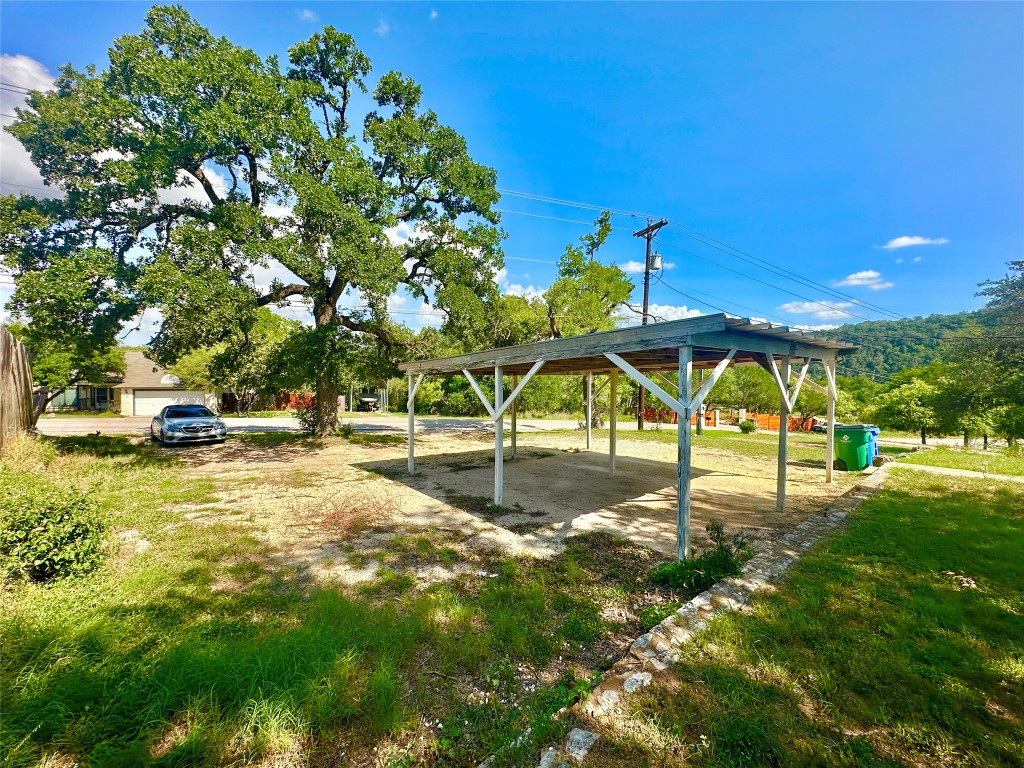 1302 South Quinlan Park Road Austin, TX 78732 - Photo 3 of 40 View of yard with a carport