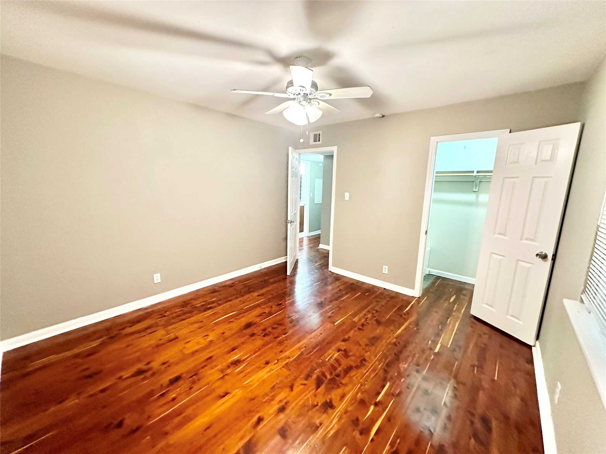 1302 South Quinlan Park Road Austin, TX 78732 - Photo 35 of 40 an empty room with wooden floor and fan