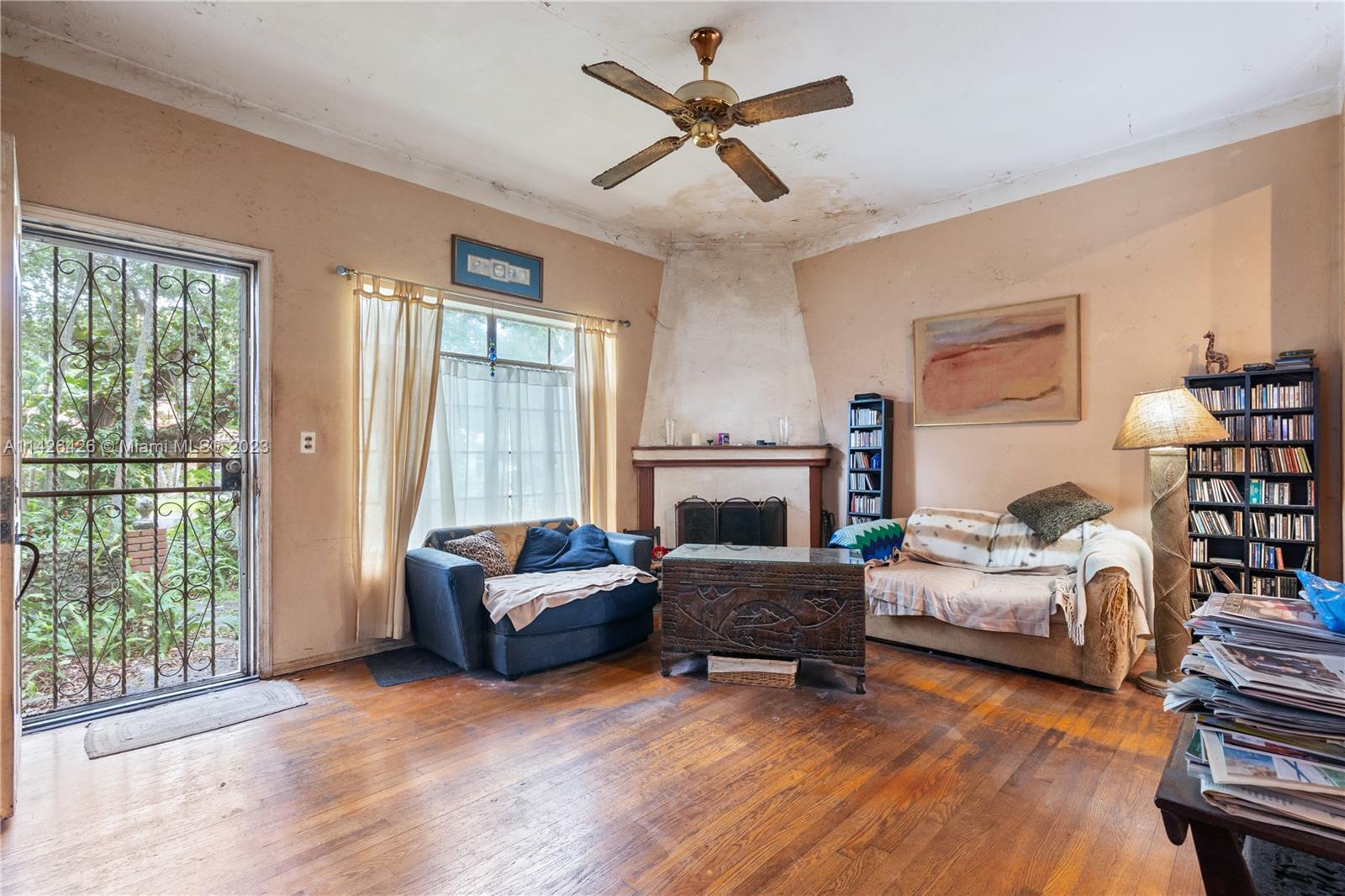 355 Northeast 86th Street El Portal, FL 33138 - Photo 2 of 23 a living room with furniture and a fireplace
