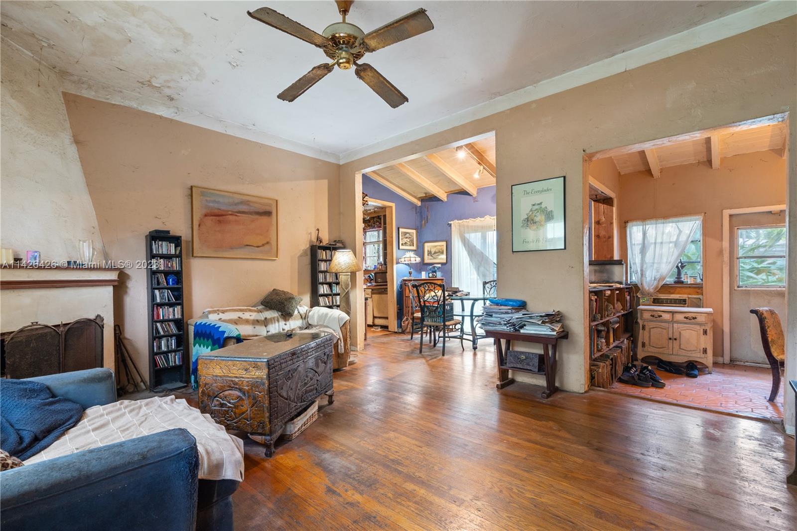 355 Northeast 86th Street El Portal, FL 33138 - Photo 3 of 23 a living room with fireplace furniture and a wooden floor
