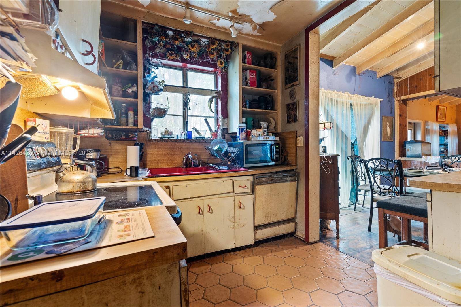 355 Northeast 86th Street El Portal, FL 33138 - Photo 8 of 23 a view of a kitchen with furniture and a window
