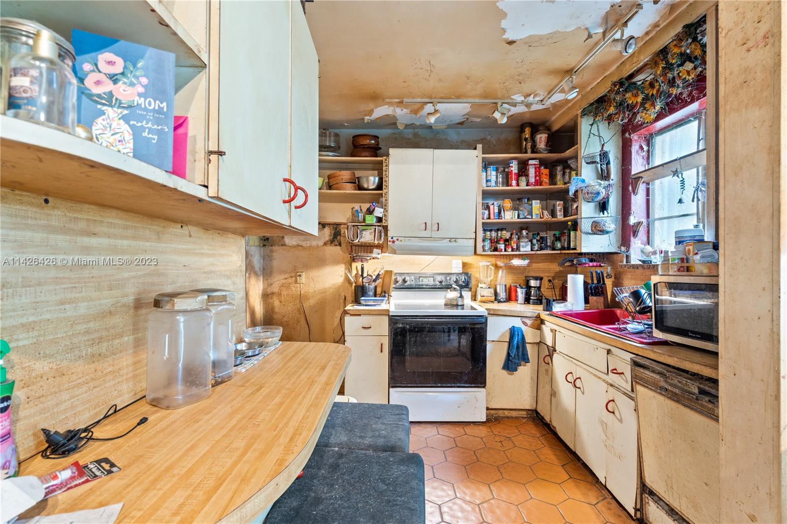 355 Northeast 86th Street El Portal, FL 33138 - Photo 9 of 23 a kitchen with stainless steel appliances granite countertop a stove and cabinets
