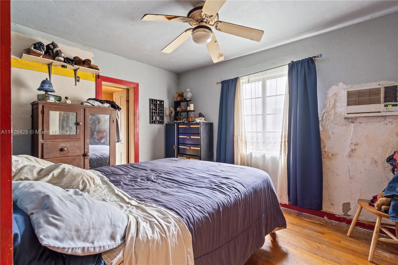 355 Northeast 86th Street El Portal, FL 33138 - Photo 10 of 23 a bedroom with a bed and a chandelier