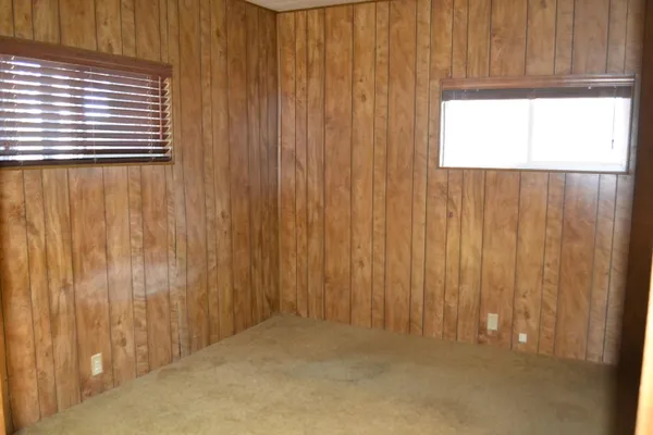 a view of a hallway with wooden walls