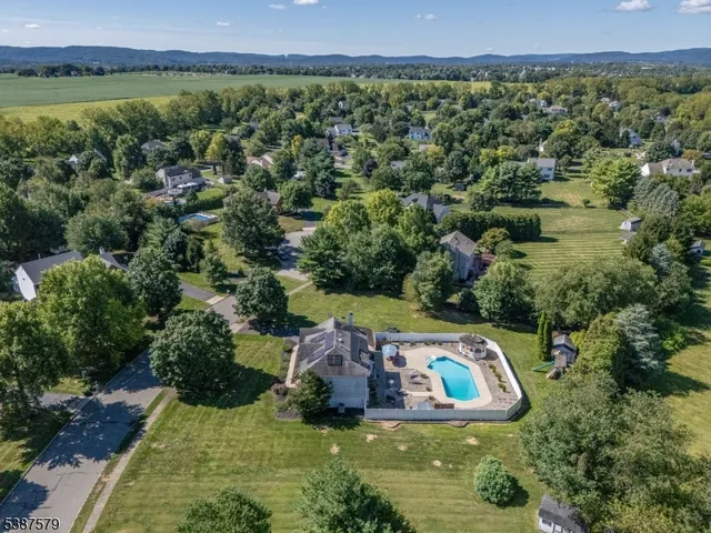 an aerial view of a house with a garden and lake view