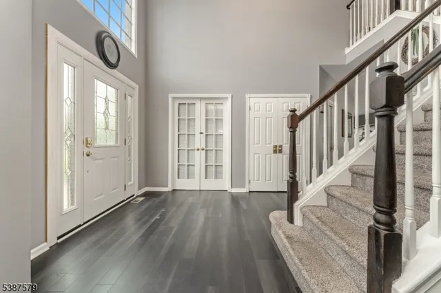 a view of an entryway with wooden floor and stairs
