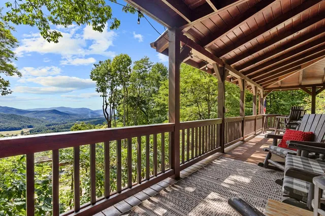 a bed sitting in a spacious bedroom next to a window