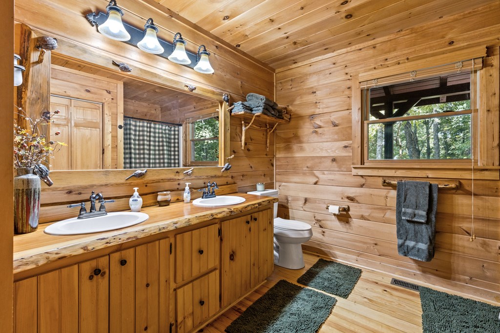 16 Enchanting Circle Morganton, GA 30560 - Photo 18 of 57 a spacious bathroom with a double vanity sink a mirror and a shower