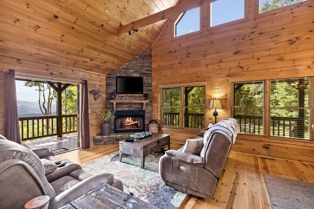 a living room with furniture a fireplace and a flat screen tv