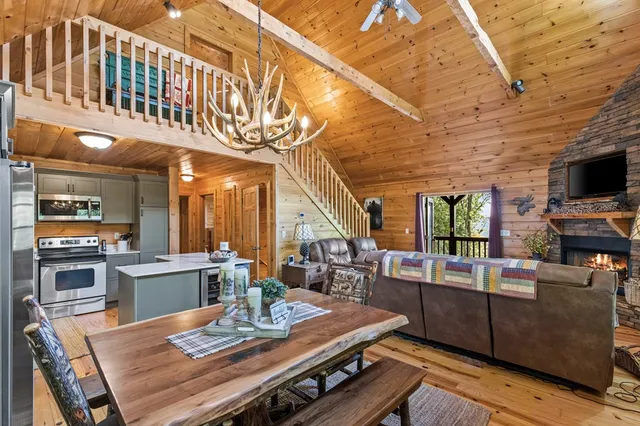 a living room with furniture a fireplace a flat screen tv and a tree