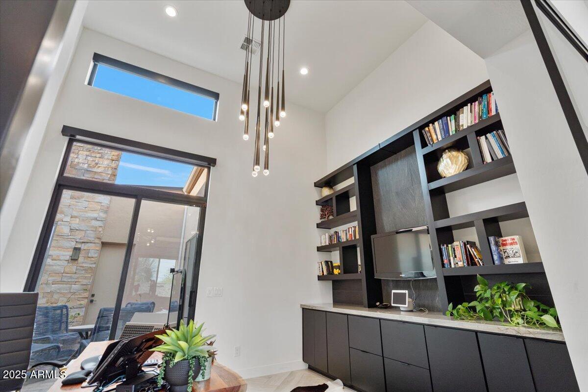 17237 East Desert Vista Trail Rio Verde, AZ 85263 - Photo 35 of 95 a living room with lots of furniture and a book shelf