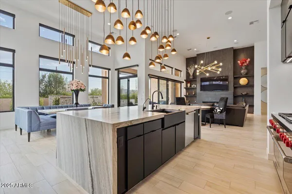 a dining room with wooden floor a chandelier a wooden table and chairs