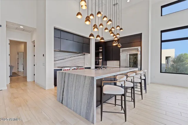 a dining room with wooden floor and a rug