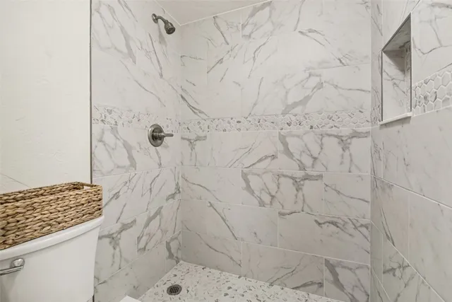 a bathroom with a granite countertop sink a mirror and a bathtub