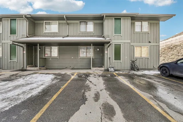 a car parked in front of a white house