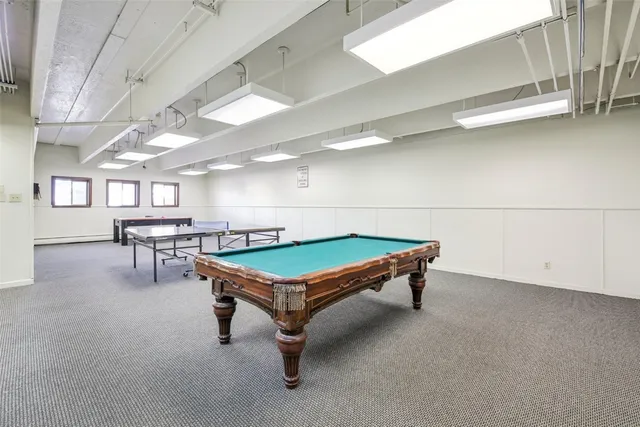 a room with table and paintings on the wall
