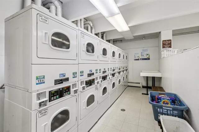 a view of a kitchen with sink washer and dryer