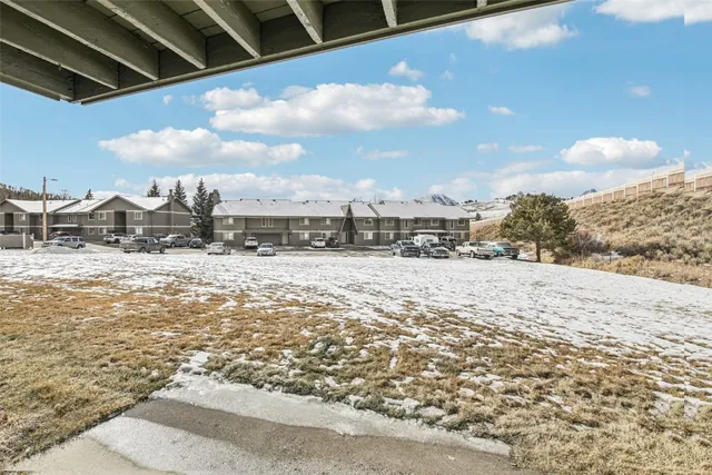 a kitchen with granite countertop a stove a sink and a refrigerator