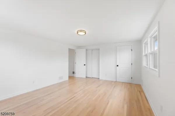 a view of an empty room and wooden floor