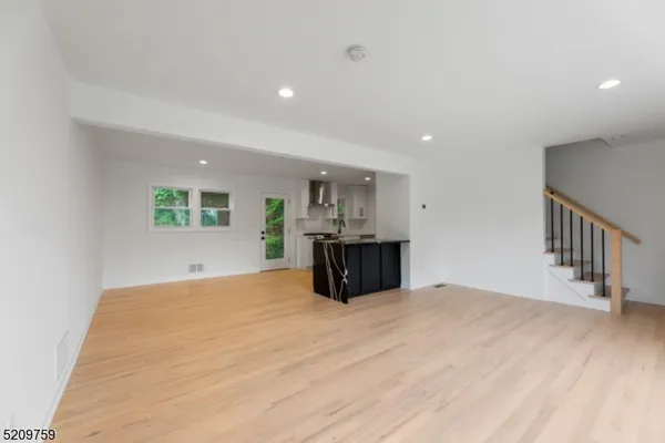 a view of kitchen and hall with wooden floor