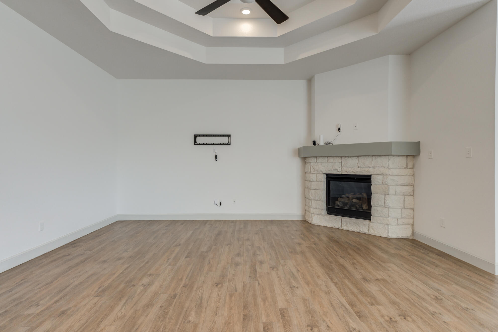 6805 51st Street Lubbock, TX 79407 - Photo 15 of 41 a view of an empty room with wooden floor and a fireplace