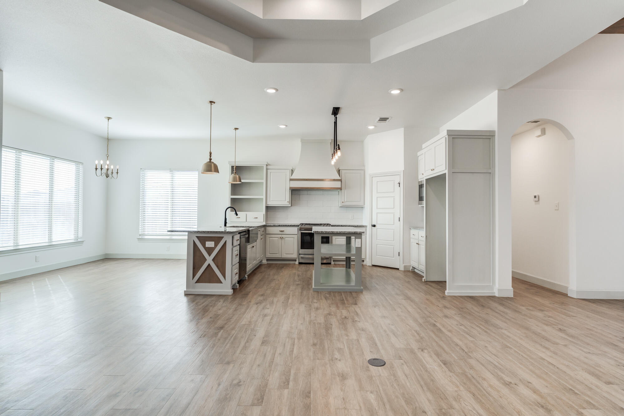 6805 51st Street Lubbock, TX 79407 - Photo 18 of 41 a large kitchen with stainless steel appliances refrigerator wooden floor dining table and chairs