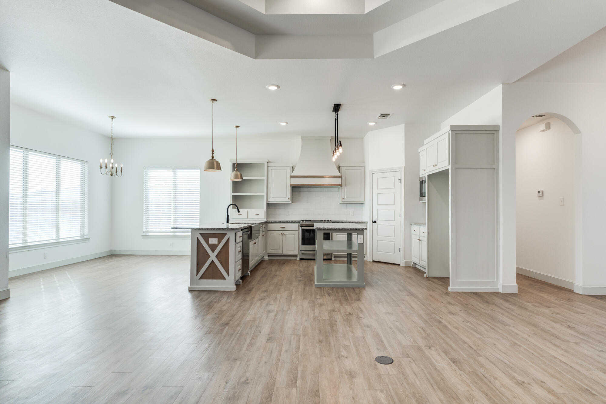 6805 51st Street Lubbock, TX 79407 - Photo 19 of 41 an open kitchen with white cabinets and stainless steel appliances