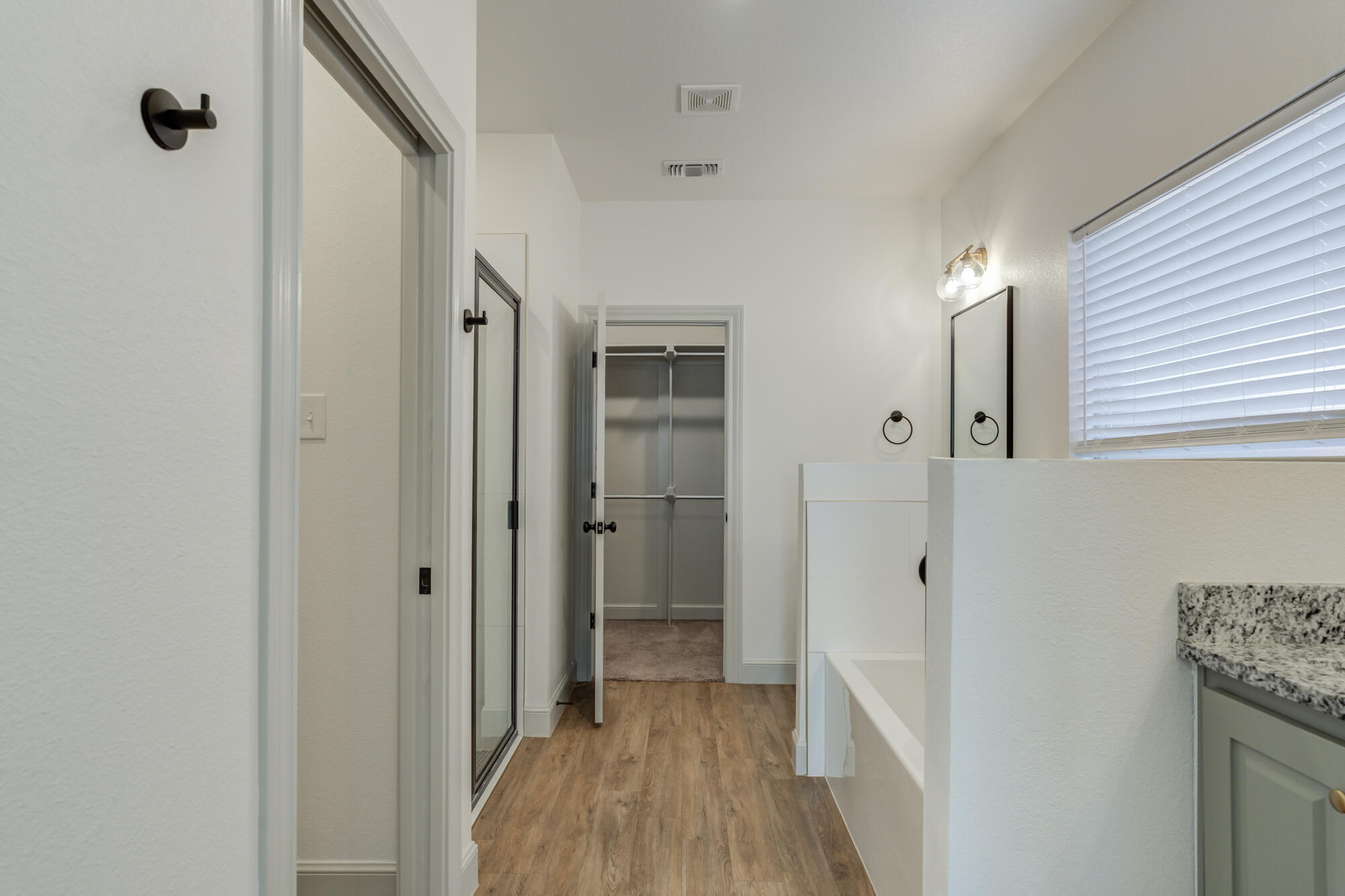6805 51st Street Lubbock, TX 79407 - Photo 22 of 41 a view of a hallway with a wooden cabinets