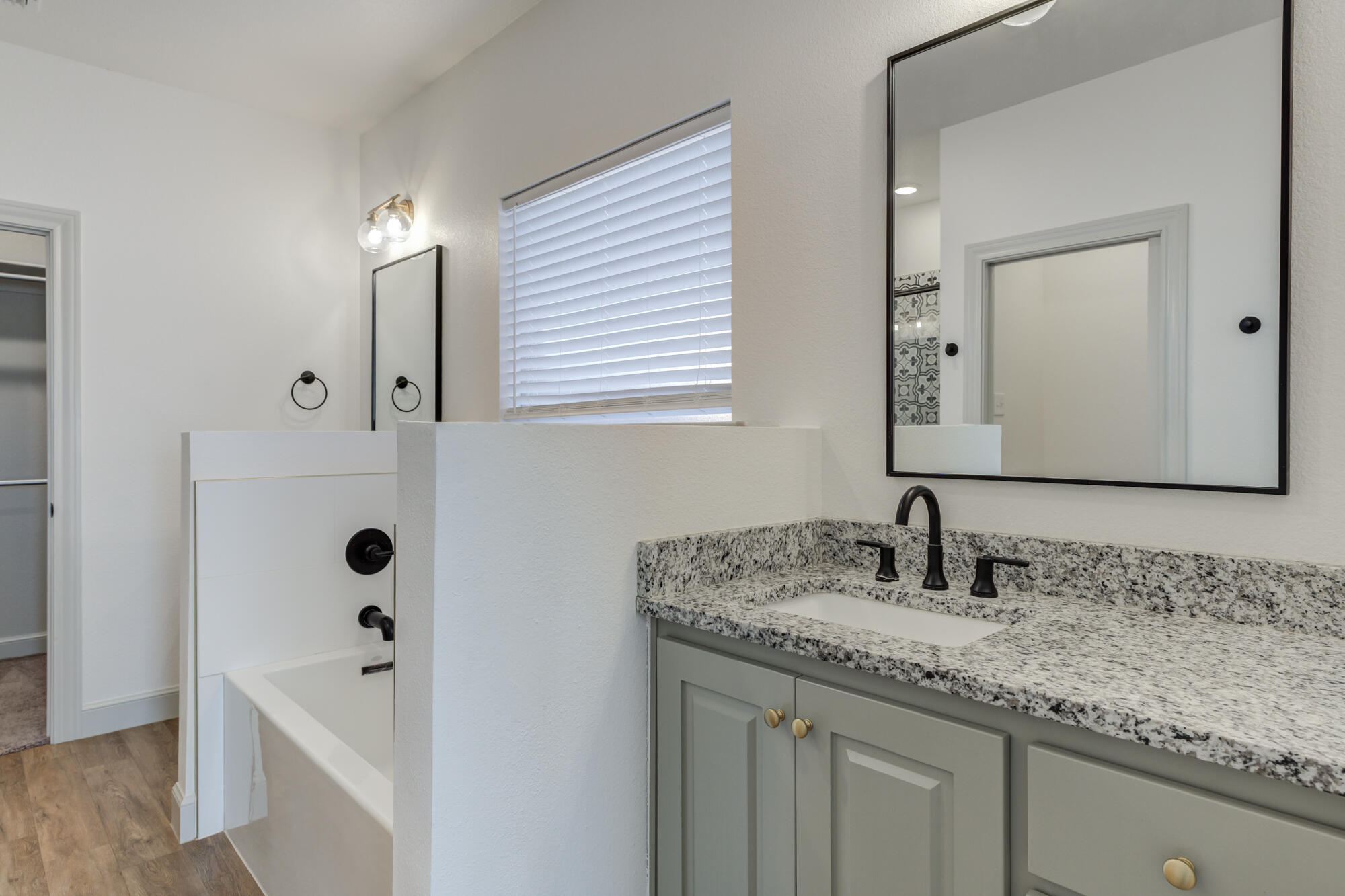 6805 51st Street Lubbock, TX 79407 - Photo 24 of 41 a bathroom with a granite countertop sink and a mirror