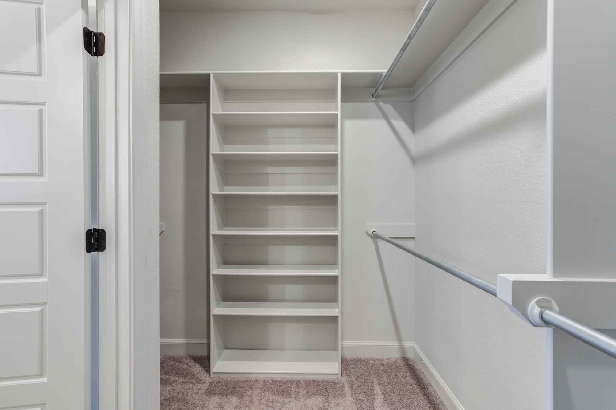 6805 51st Street Lubbock, TX 79407 - Photo 27 of 41 a view of walk in closet with empty racks