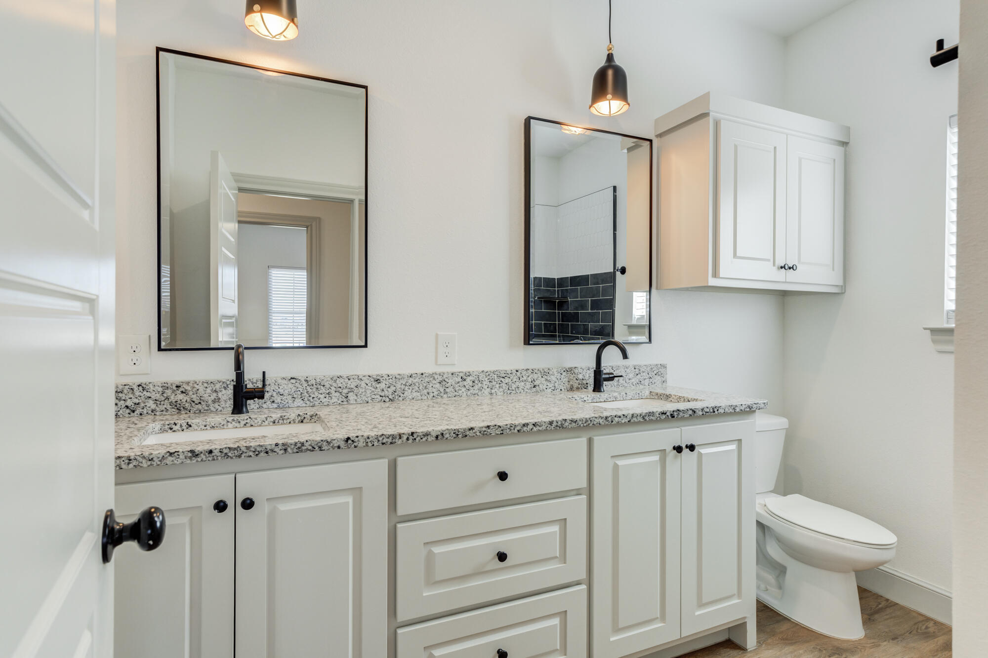 6805 51st Street Lubbock, TX 79407 - Photo 30 of 41 a bathroom with a granite countertop sink and a mirror