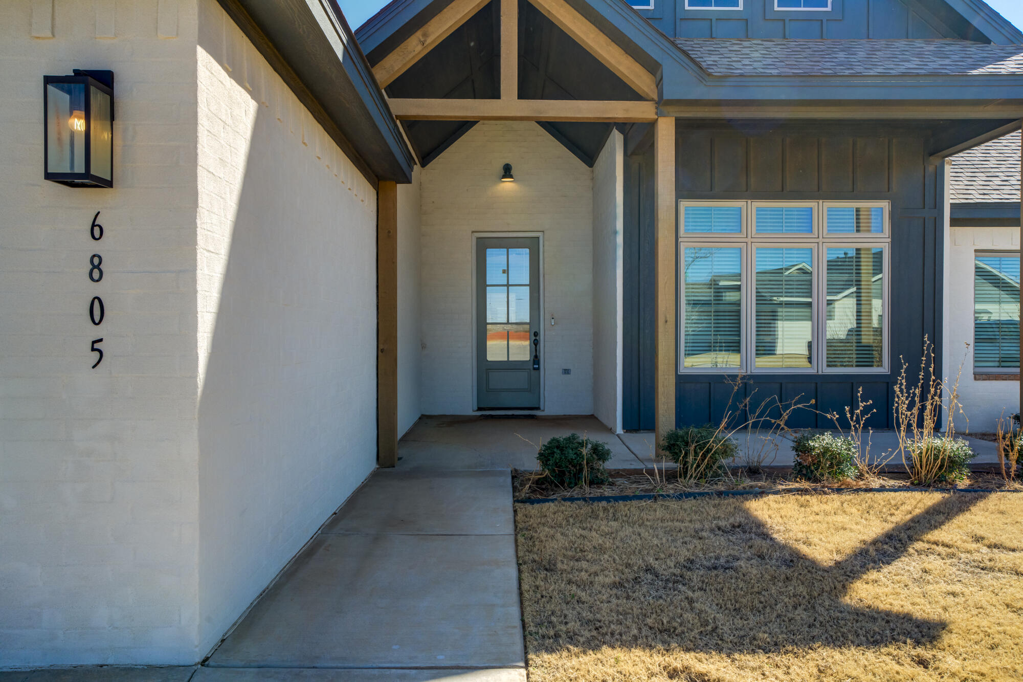 6805 51st Street Lubbock, TX 79407 - Photo 3 of 41 a front view of a house with garden
