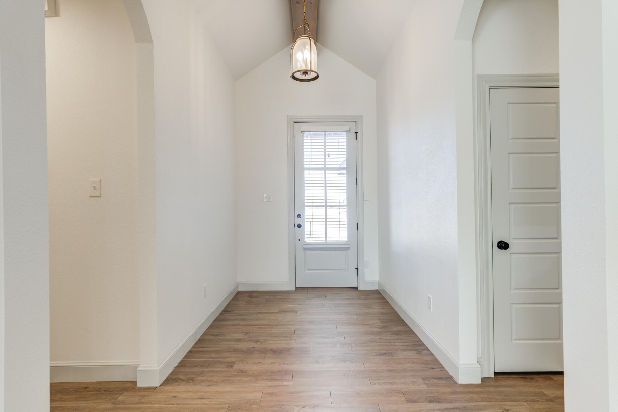 6805 51st Street Lubbock, TX 79407 - Photo 5 of 41 an empty room with wooden floor cabinet and windows
