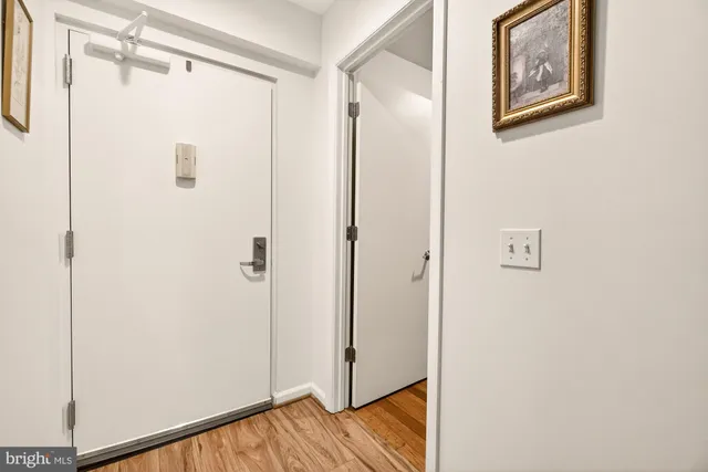a view of a room with window and hardwood floor
