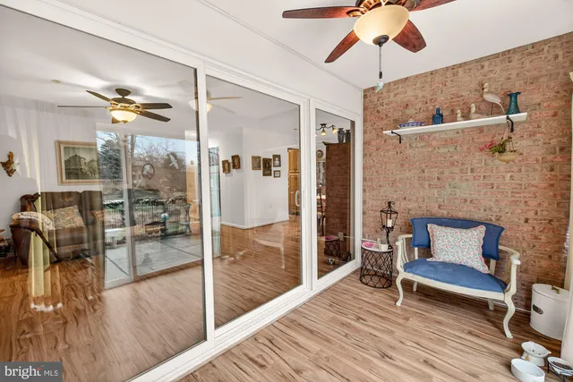 a view of a patio with couches and table and chairs next to yard and trees