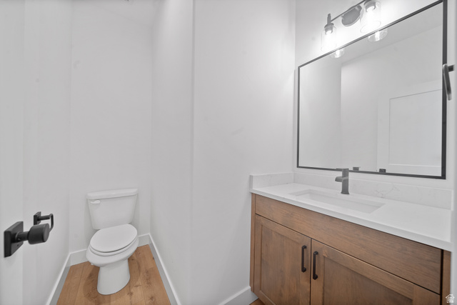 1117 East Shilow Road, Unit 106 Erda, UT 84074 - Photo 18 of 21 Powder room featuring a wood-finish vanity with an integrated sink, white countertop, and matte black fixtures