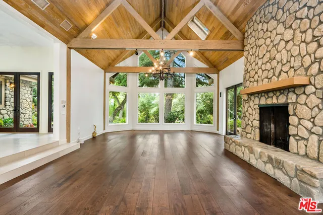 a view of an entryway with a floor to ceiling window and wooden floor