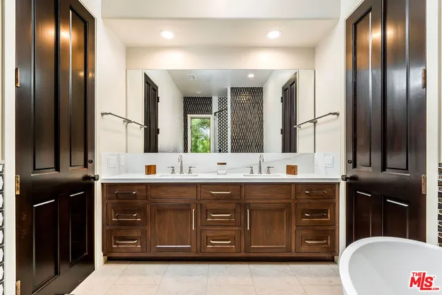 a bathroom with a double vanity sink and a mirror