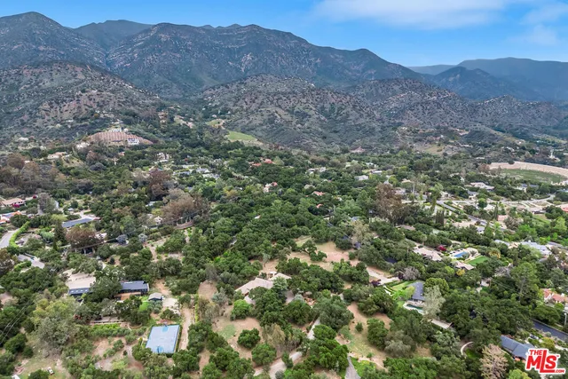 a view of a lush green hillside and houses