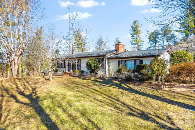 a view of a house with swimming pool and sitting area