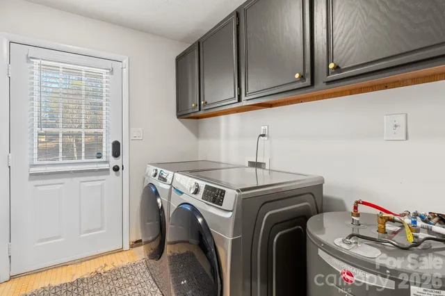 a utility room with sink dryer and washer