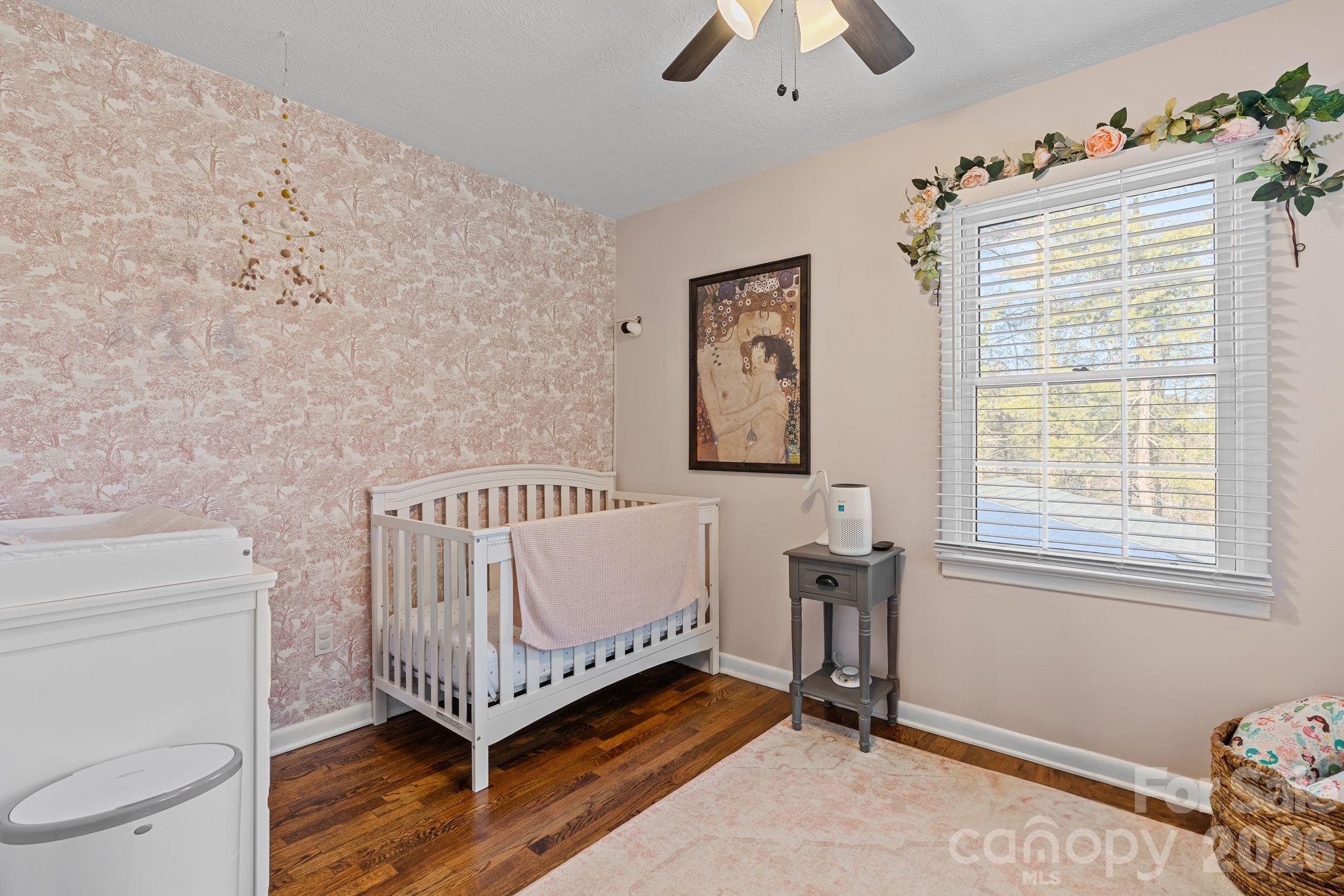 1348 Jenkins Valley Road Alexander, NC 28701 - Photo 17 of 44 a bed sitting in a bedroom next to a window