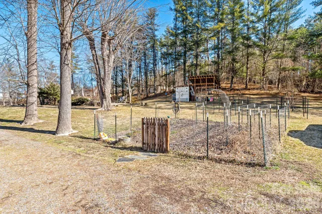 a view of a yard with wooden fence