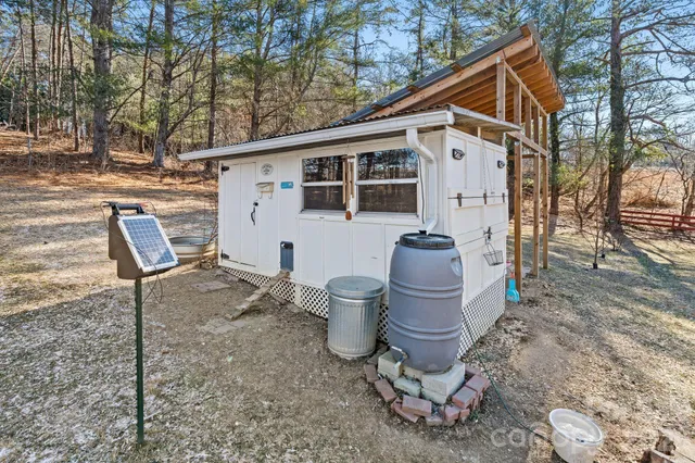 a view of a chair and table in backyard