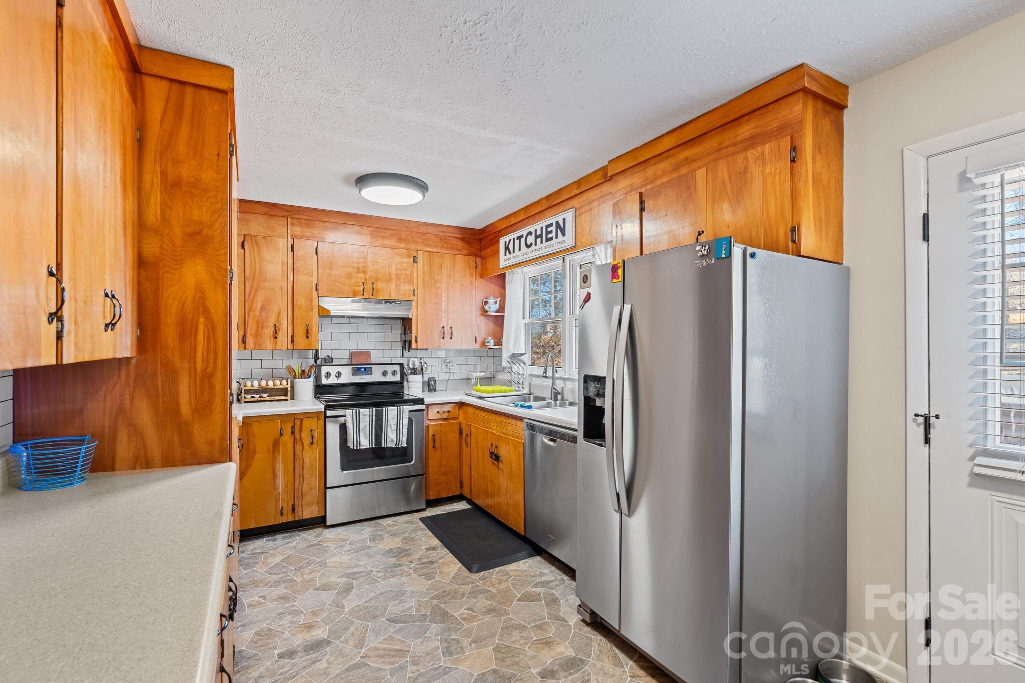 1348 Jenkins Valley Road Alexander, NC 28701 - Photo 6 of 44 a kitchen with stainless steel appliances granite countertop a refrigerator and a stove