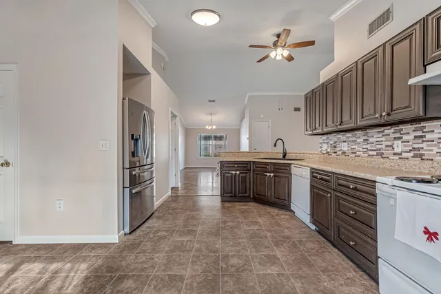 a kitchen with refrigerator cabinets and a sink