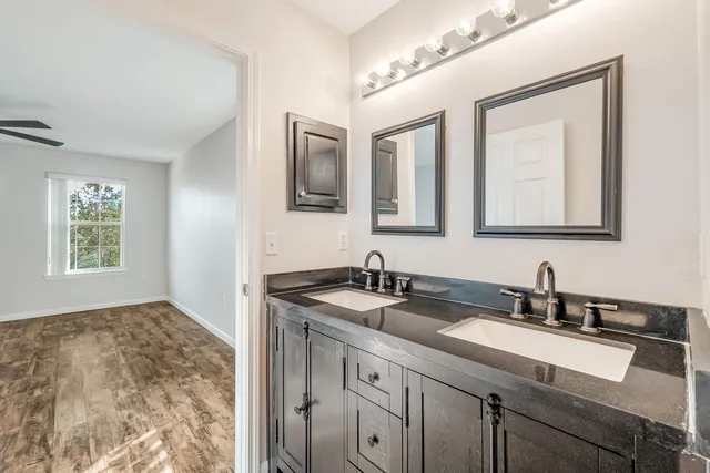 a bathroom with double sink and a mirror